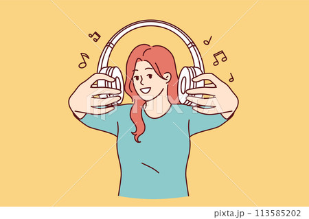 Wireless headphones in hands of woman inviting you to listen to popular songs or radio together Wireless headphones in hands of woman inviting you to listen to popular songs or radio together 113585202