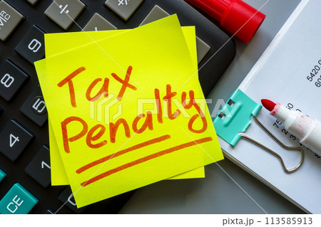 Tax penalty concept. Calculator with a sticker on it. 113585913