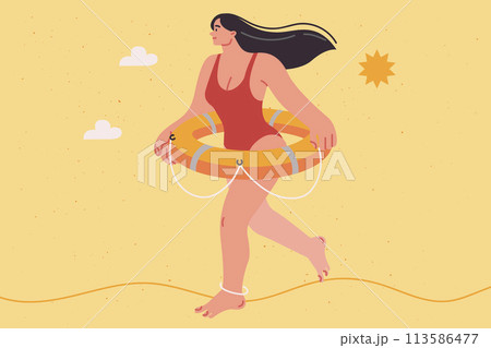 Woman beach lifeguard dressed in swimsuit walks along seashore with lifebuoy on belt Woman beach lifeguard dressed in swimsuit walks along seashore with lifebuoy on belt 113586477