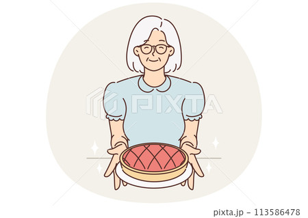 Smiling old grandmother hold homemade pie Smiling old grandmother hold homemade pie 113586478