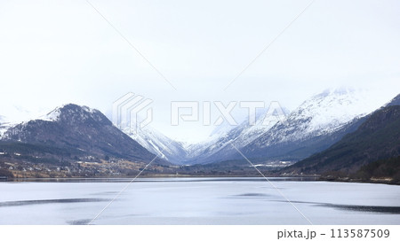The view from the Andalsnes waterfront looking towards Isfjorden, Norway.  Isfjorden is a small village in the Rauma Valley on the shores of Romsdalsfjord. 113587509