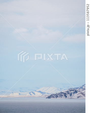snow-covered mountains in distance and coldness sea 113587952