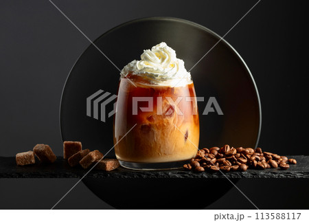 Iced coffee with whipped cream and caramel sauce. 113588117