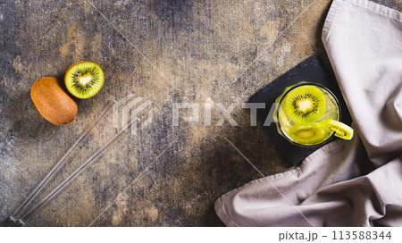 Refreshing tropical drink mojito with kiwi in glasses on the table top view web banner 113588344