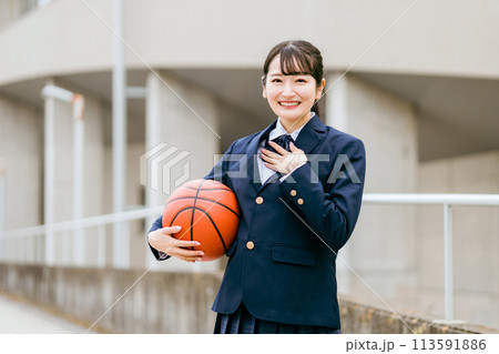 校舎の前でバスケットボールを持つ女子中学生・女子高生（部活・スポーツ・運動部・バスケ部） 113591886