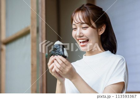 縁側でおにぎりを食べる可愛い女性 縁側でおにぎりを食べる可愛い女性 113593367