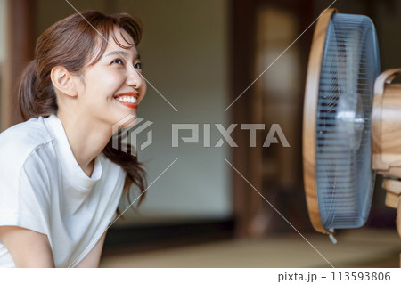 扇風機で涼むかわいい女性 113593806