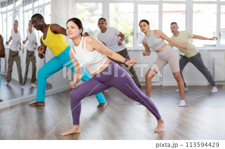 Young Asian woman practicing hip-hop dance in training hall 113594429