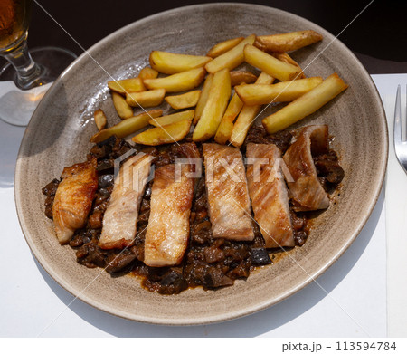 Iberian pork in sweet wine with stewed vegetables. Iberian pork in sweet wine with stewed vegetables. 113594784