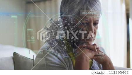 Scope scanning over covid-19 cells against thoughtful caucasian senior woman sitting at home 113595462