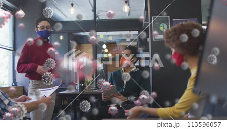 Image of covid 19 cells over colleagues in office wearing face masks Image of covid 19 cells over colleagues in office wearing face masks 113596057
