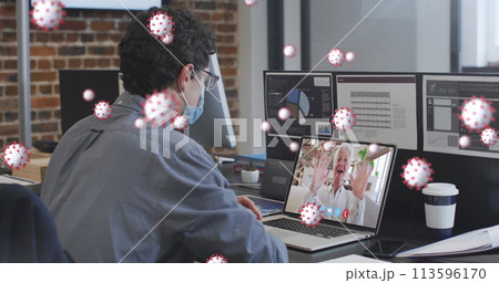 Image of covid 19 cells over man in face mask using laptop on image call Image of covid 19 cells over man in face mask using laptop on image call 113596170