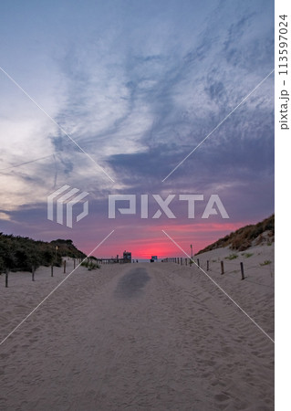 Sandy Path to the Beach Under a Vibrant Sunset Sky Sandy Path to the Beach Under a Vibrant Sunset Sky 113597024