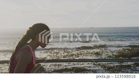 Image of rising number of subscribers over woman jogging on promenade by the sea 113598018