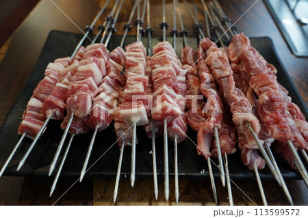 Fresh raw lamb skewers in restaurant 113599572