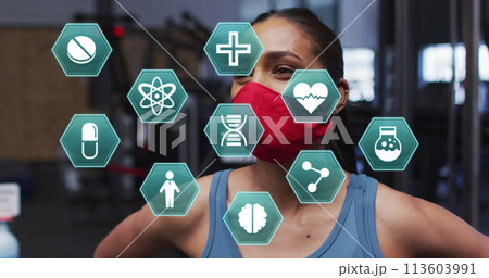 Image of medical icons over caucasian woman wearing face mask sneezing Image of medical icons over caucasian woman wearing face mask sneezing 113603991