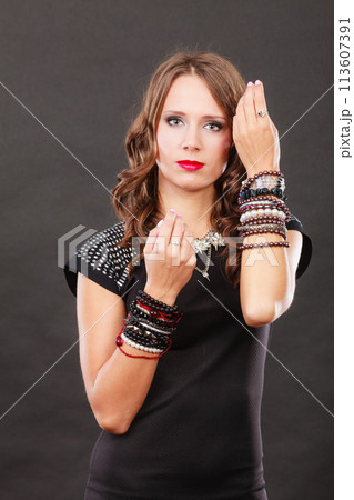 woman with jewellery in black evening dress 113607391