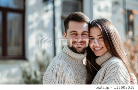A man and woman in a sweater pose for the camera  113608019