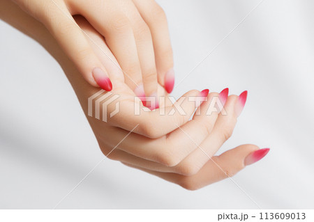Girl's hands with a beautiful pale pink ombre Girl's hands with a beautiful pale pink ombre 113609013