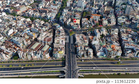 Amazing aerial view by drone of Ho Chi Minh, big Asian city with crowded townhouse, vehicle circulate on street move to intersection, house close together of residence area, cityscape skyline at 113612230