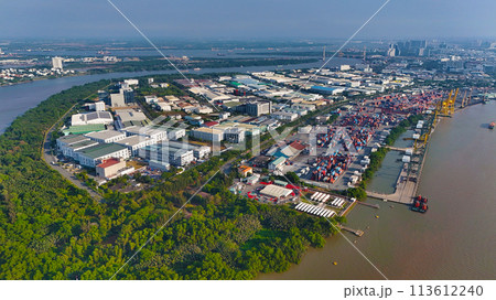 Aerial view from drone of Ho Chi Minh city port, canal system for traffic waterway on Saigon river, crane and container at riverside harbor, logistic for export, import industrial with cheap expense Aerial view from drone of Ho Chi Minh city port, canal system for traffic waterway on Saigon river, crane and container at riverside harbor, logistic for export, import industrial with cheap expense 113612240