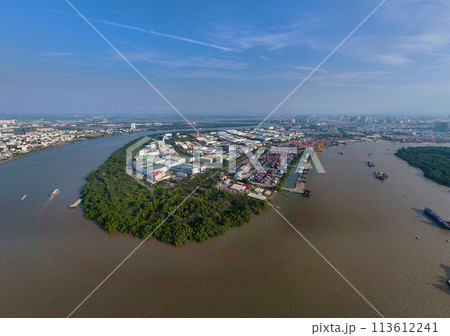 Aerial view from drone of Ho Chi Minh city port, canal system for traffic waterway on Saigon river, crane and container at riverside harbor, logistic for export, import industrial with cheap expense Aerial view from drone of Ho Chi Minh city port, canal system for traffic waterway on Saigon river, crane and container at riverside harbor, logistic for export, import industrial with cheap expense 113612241