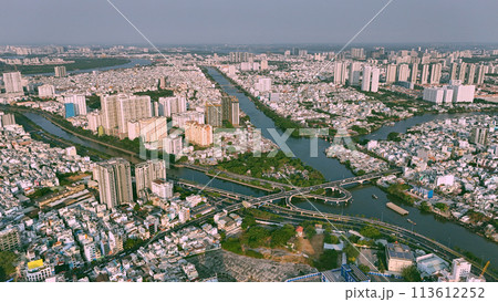 Aerial view from drone of Ho Chi Minh, big Asian city with row of crowded house, Nhieu Loc Thi Nghe canal, Y bridge cross water, vehicle traffic on road, level 4 house slum Aerial view from drone of Ho Chi Minh, big Asian city with row of crowded house, Nhieu Loc Thi Nghe canal, Y bridge cross water, vehicle traffic on road, level 4 house slum 113612252