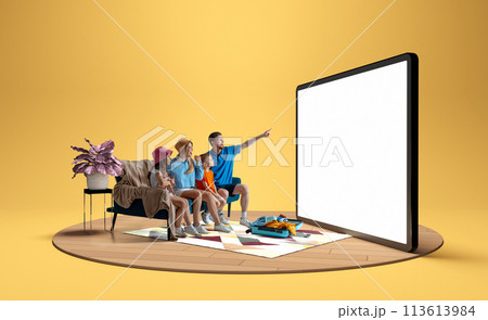 Family, man, woman and children sitting on sofa at home and pointing at giant 3D model of tablet, booking hotels and tickets via online services Family, man, woman and children sitting on sofa at home and pointing at giant 3D model of tablet, booking hotels and tickets via online services 113613984
