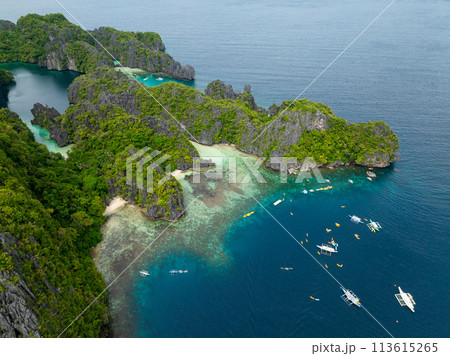 Big Lagoon in Miniloc Island. Boats and kayak over the blue sea. El Nido, Palawan. Philippines. 113615265