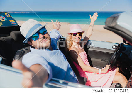 Happy couple travels by car on summer vacation 113617813