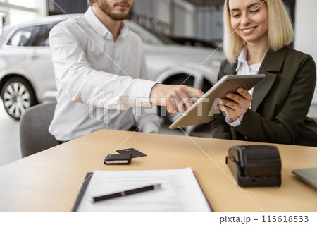 Caucasian rich man customer buyer client in suit sign contract on tablet. Caucasian rich man customer buyer client in suit sign contract on tablet. 113618533