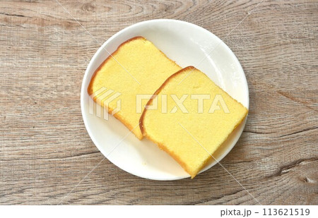 butter vanilla cheesecake cutting in square shape on plate 113621519