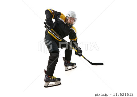 Male athlete, hockey player in black uniform and helmet training, competing isolated on white background 113621612