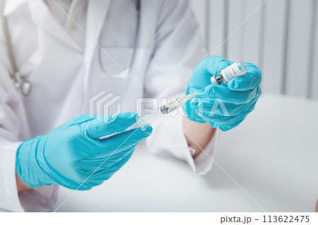 Doctor or researcher load covid-19 vaccine into syringe. Researchers are inventing vaccines to treat COVID-19 virus. 113622475