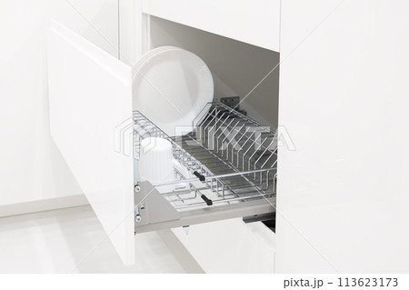 Open kitchen drawer with metal dish dry rack Open kitchen drawer with metal dish dry rack 113623173