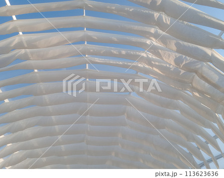 White design strips sheds awning with fabric white curtains on the seashore breeze  113623636