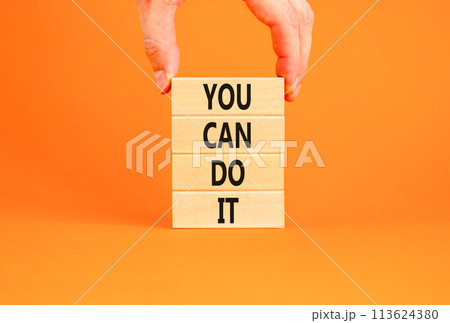 You can do it symbol. Concept word You can do it on beautiful wooden block. Beautiful orange table orange background. Businessman hand. Business motivational you can do it concept. Copy space. 113624380