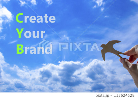 CYB Create your brand symbol. Concept words CYB Create your brand on beautiful blue sky clouds background. Wooden bird. Businessman hand. Business CYB Create your brand concept. Copy space. CYB Create your brand symbol. Concept words CYB Create your brand on beautiful blue sky clouds background. Wooden bird. Businessman hand. Business CYB Create your brand concept. Copy space. 113624529