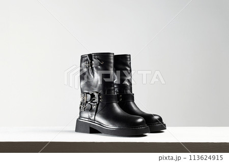 Trendy shoes. fashion still life. classic black boots Trendy shoes. fashion still life. classic black boots 113624915