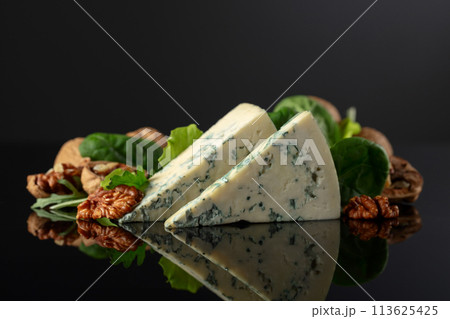 Blue cheese with walnuts and fresh greens. 113625425