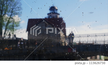 Silhouettes of a couple in love standing on a honey bridge in a fishing village. Kaliningrad, a look through the glass. 113626730