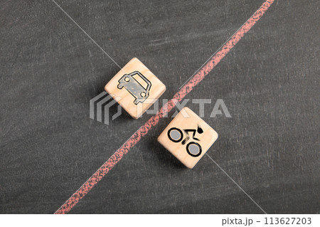 Conflict between drivers and cyclists. wooden blocks on a dark chalkboard background 113627203