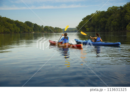 Couple kayaking in river Couple kayaking in river 113631325
