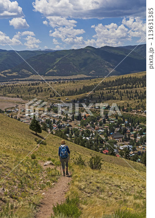 USA, Colorado, Creede, Rear view of woman hiking near town USA, Colorado, Creede, Rear view of woman hiking near town 113631385