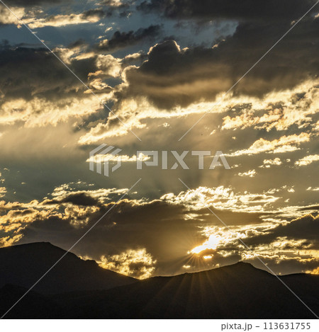 Silhouette of mountains with sunrise in background 113631755