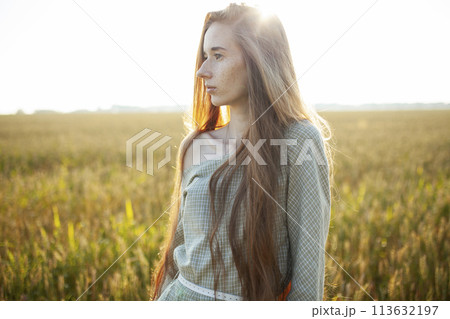 Beautiful woman posing in rural area 113632197