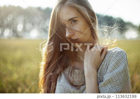 Beautiful woman posing in rural area 113632199