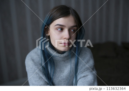 Portrait of serious woman in gray sweater 113632364