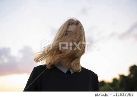 Portrait of mystery woman at sunset 113632368