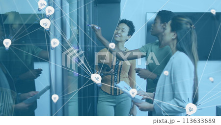 Image of data processing over diverse business people taking notes in office Image of data processing over diverse business people taking notes in office 113633689